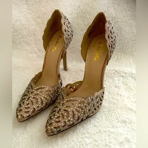 4 1/2 inch heels. Iridescent sparkle gold/beige with Cut-out design. Worn once.